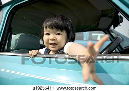 Portrait of girl in car, reaching hand View Large Photo Image Stock Image - Portrait of girl in car, reaching hand. Fotosearch