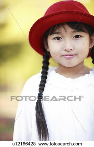 Stock Photo - Portrait of girl in red hat, Kobe city, Hyogo prefecture, Japan. Fotosearch