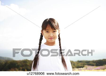 Stock Photograph - Portrait of girl in the field, Awaji city, Hyogo prefecture, Japan. Fotosearch