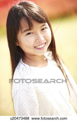 Stock Photo - Portrait of girl smiling, Awaji city, Hyogo prefecture, Japan. Fotosearch