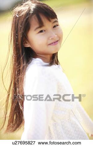 Stock Photo - Portrait of girl smiling, Awaji city, Hyogo prefecture, Japan. Fotosearch