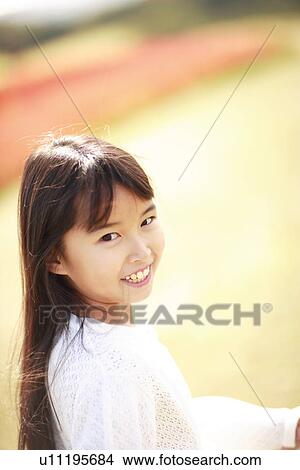 Portrait of girl smiling, differential focus, Awaji city, Hyogo prefecture, Japan View Large Photo Image Picture - Portrait of girl smiling, differential focus, Awaji city, Hyogo prefecture, Japan. Fotosearch