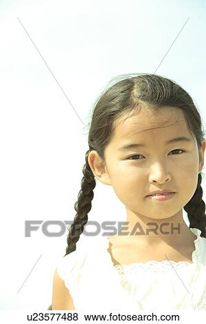Stock Photo - Portrait of girl under sky, Awaji city, Hyogo prefecture, Japan. Fotosearch