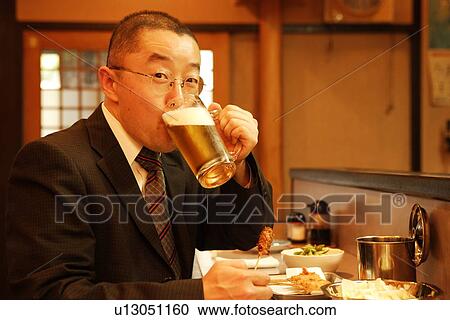 Portrait of mature man sitting at bar counter, drinking glass of beer View Large Photo Image Stock Image - Portrait of mature man sitting at bar counter, drinking glass of beer. Fotosearch