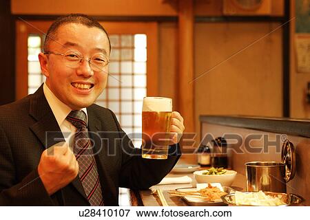 Portrait of mature man sitting at bar counter, holding glass of beer View Large Photo Image Stock Photo - Portrait of mature man sitting at bar counter, holding glass of beer. Fotosearch
