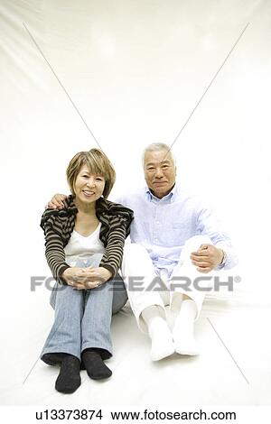 Portrait of mature woman and senior man, sitting, white background View Large Photo Image Picture - Portrait of mature woman and senior man, sitting, white background. Fotosearch