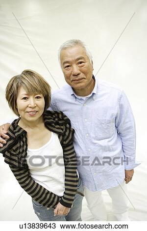 Stock Image - Portrait of mature woman and senior man, smiling, white background. Fotosearch