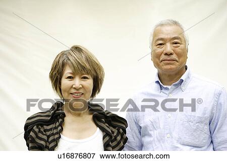 Stock Photo - Portrait of mature woman and senior man, smiling, white background. Fotosearch