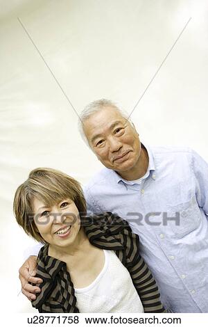 Stock Photo - Portrait of mature woman and senior man, smiling, white background. Fotosearch
