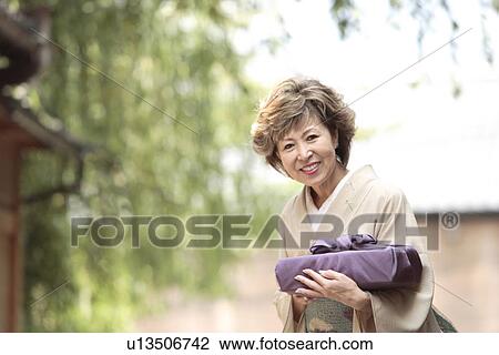 Portrait of mature woman in Kimono holding gift, Kyoto city, Kyoto prefecture, Japan View Large Photo Image Stock Image - Portrait of mature woman in Kimono holding gift, Kyoto city, Kyoto prefecture, Japan. Fotosearch