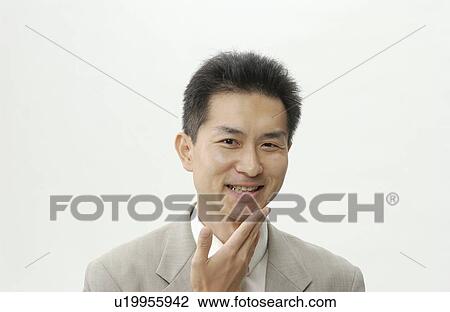Stock Image - Portrait of Mid Adult Man in Business Suit. Fotosearch