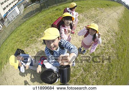 Portrait of school children at riverbank, fish-eye lens View Large Photo Image Picture - Portrait of school children at riverbank, fish-eye lens. Fotosearch