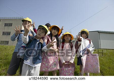 Stock Image - Portrait of school children at riverbank. Fotosearch