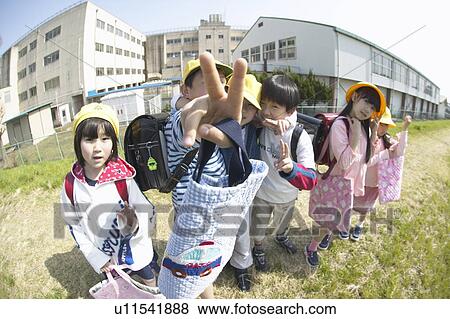Portrait of school children at riverbank, making peace sign, fish-eye lens View Large Photo Image Stock Photo - Portrait of school children at riverbank, making peace sign, fish-eye lens. Fotosearch