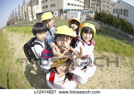 Stock Photo - Portrait of school children at riverbank, fish-eye lens. Fotosearch
