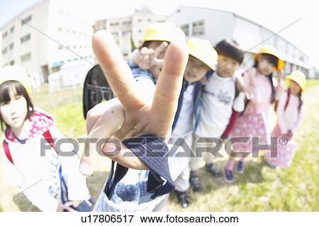 Portrait of school children at riverbank, making peace sign, fish-eye lens View Large Photo Image Stock Photo - Portrait of school children at riverbank, making peace sign, fish-eye lens. Fotosearch