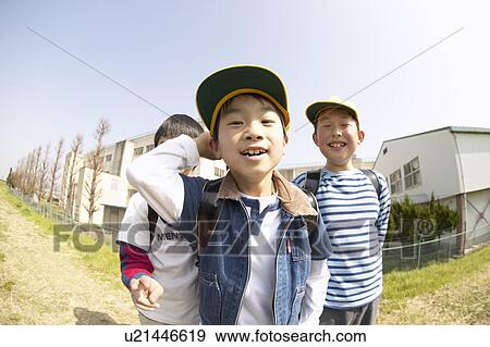 Stock Photo - Portrait of schoolboys at riverbank, fish-eye lens. Fotosearch