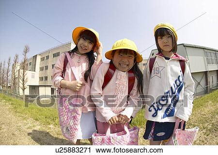 Stock Image - Portrait of schoolgirls at riverbank, fish-eye lens. Fotosearch