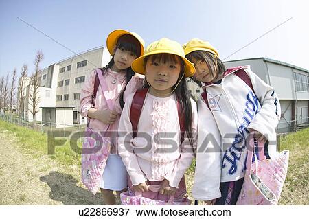 Stock Photo - Portrait of schoolgirls at riverbank, fish-eye lens. Fotosearch