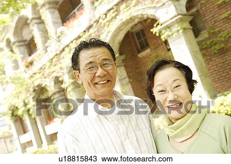 Stock Image - Portrait of senior couple at street. Fotosearch