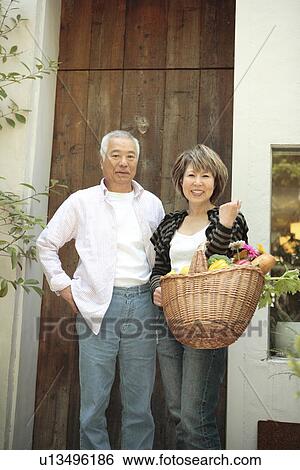 Portrait of senior man and mature woman standing in doorway View Large Photo Image Stock Photograph - Portrait of senior man and mature woman standing in doorway. Fotosearch
