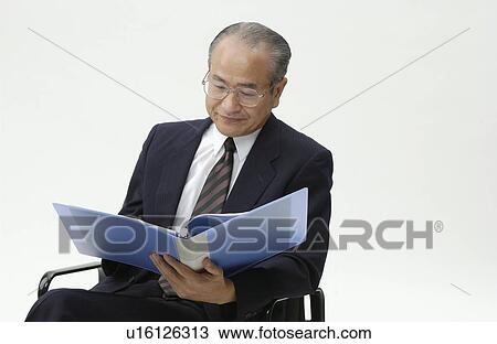 Stock Image - Portrait of Senior Man in Business Suit, Looking at File. Fotosearch