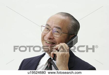 Stock Image - Portrait of Senior Man in Business Suit, Talking on Telephone. Fotosearch
