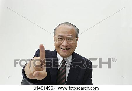 Stock Photo - Portrait of Senior Man in Business Suit, Pointing at Camera. Fotosearch