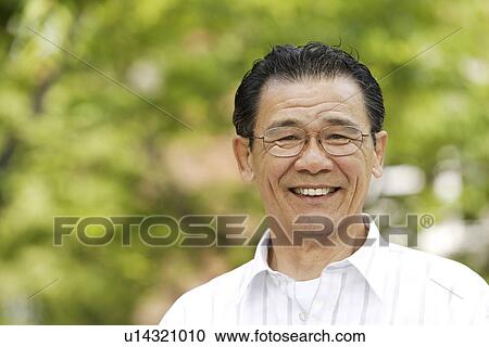 Stock Image - Portrait of senior man smiling, differential focus. Fotosearch