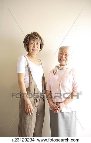 Portrait of senior woman and mature woman, smiling, white background View Large Photo Image Picture - Portrait of senior woman and mature woman, smiling, white background. Fotosearch