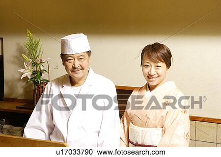 Stock Image - Portrait of woman in Kimono and Japanese chef, smiling, Kyoto city, Kyoto prefecture, Japan. Fotosearch