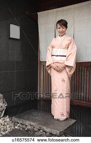 Picture - Portrait of woman in Kimono standing in Japanese restaurant entrance, Kyoto city, Kyoto prefecture, Japan. Fotosearch