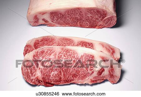Stock Photograph - Raw beef steaks, white background. Fotosearch