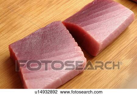 Raw tuna on cutting board, close up View Large Photo Image Stock Image - Raw tuna on cutting board, close up. Fotosearch