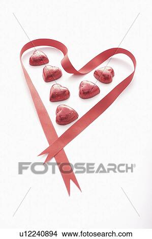 Picture - Red Heart Chocolates in Red Heart Ribbon. Fotosearch