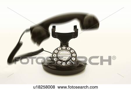 Stock Photo - Ringing old telephone, white background, blurred motion. Fotosearch