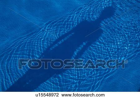 Stock Image - Rippled water and shadow of person. Fotosearch