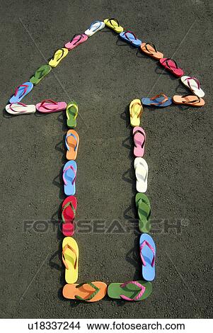 Picture - Sandals making arrow sign on beach. Fotosearch