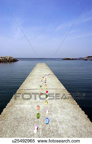 Stock Photography - Sandals placed in lines on pier, Kamakura city, Kanagawa prefecture, Japan. Fotosearch