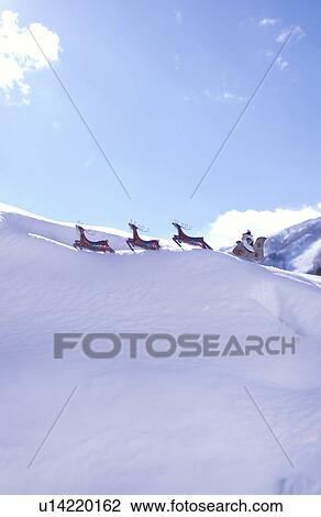 Stock Image - Santa and reindeer decoration in snow. Fotosearch