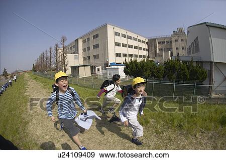 Stock Photo - Schoolboys running on riverbank, fish-eye lens. Fotosearch