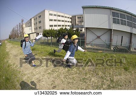 Stock Photography - Schoolboys running on riverbank, fish-eye lens. Fotosearch