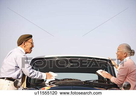 Senior couple cleaning windshield View Large Photo Image Stock Image - Senior couple cleaning windshield. Fotosearch