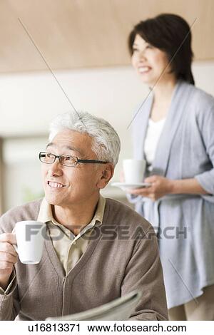 Stock Image - Senior couple drinking coffee. Fotosearch