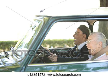 Senior couple driving a car View Large Photo Image Stock Image - Senior couple driving a car. Fotosearch