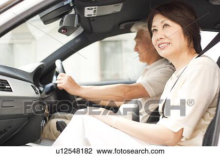 Stock Image - Senior couple in car, smiling. Fotosearch