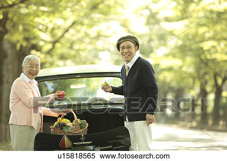 Senior couple taking out a basket full of fruits and vegetables from car trunk View Large Photo Image Stock Photography - Senior couple taking out a basket full of fruits and vegetables from car trunk. Fotosearch