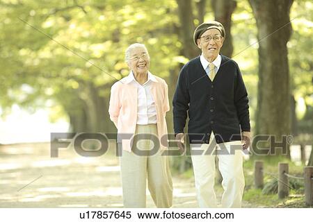 Senior couple walking treelined street View Large Photo Image Stock Photography - Senior couple walking treelined street. Fotosearch
