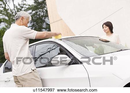 Stock Photo - Senior couple washing car. Fotosearch