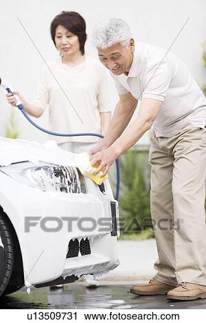 Senior couple washing car, using hose and sponge View Large Photo Image Stock Image - Senior couple washing car, using hose and sponge. Fotosearch